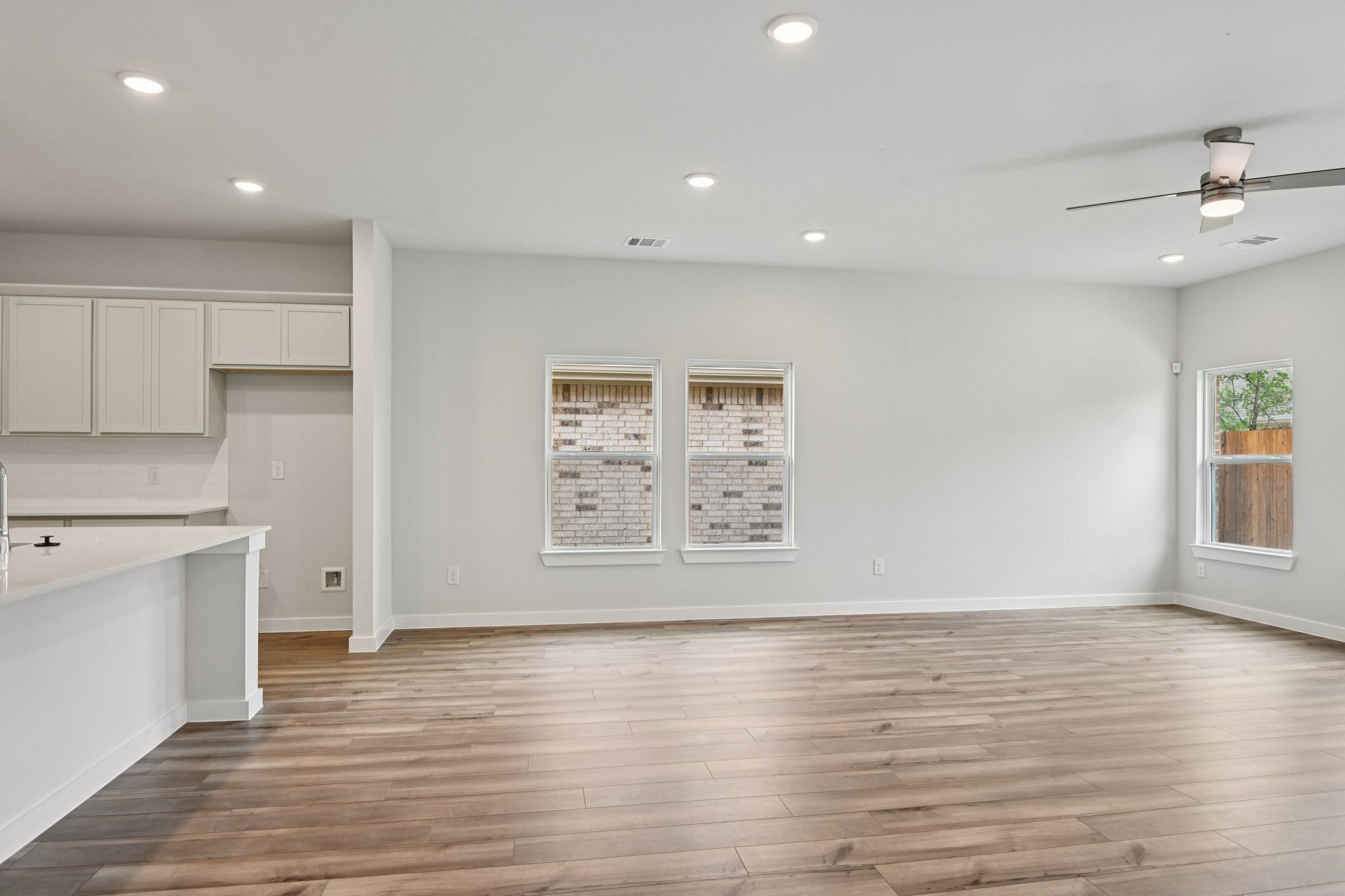 A kitchen with white cabinets.