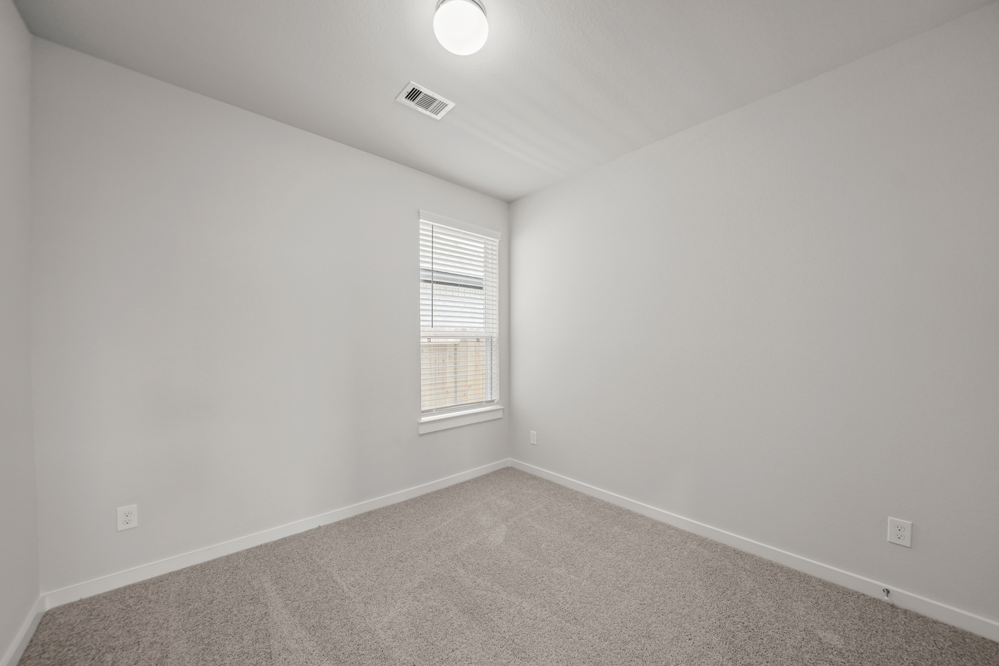 A room with a light on the ceiling.