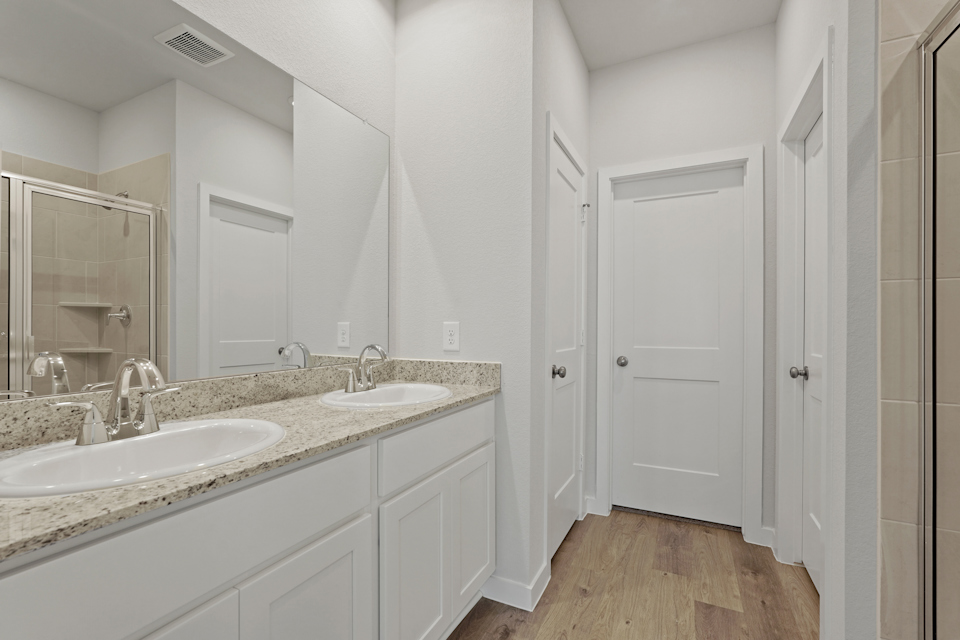 A bathroom with a large mirror.