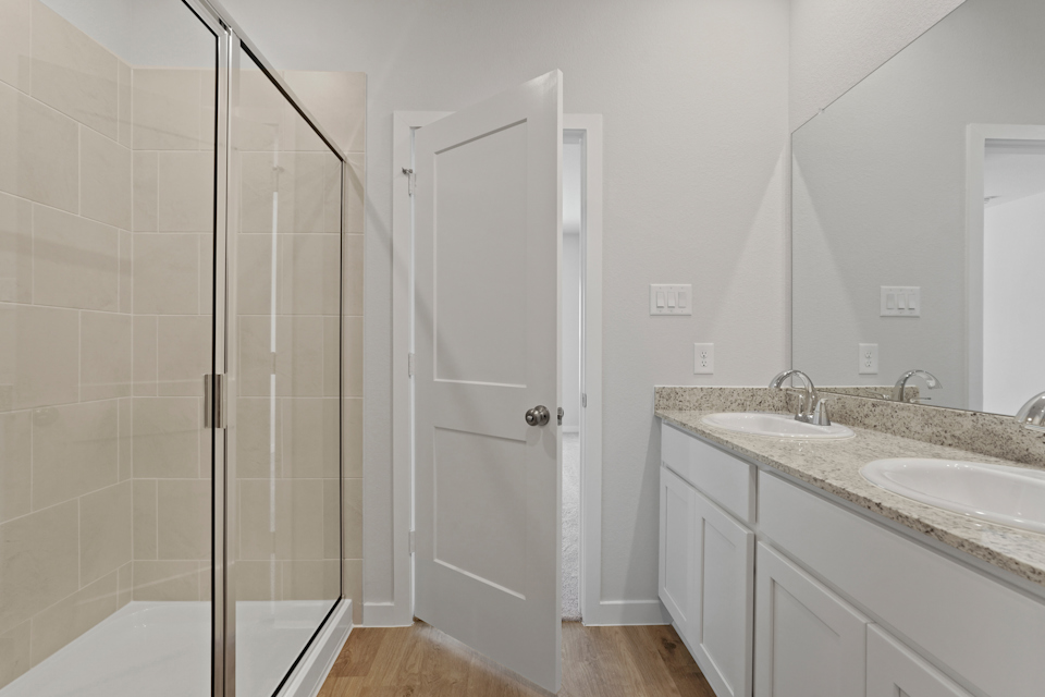 A bathroom with a shower and sink.