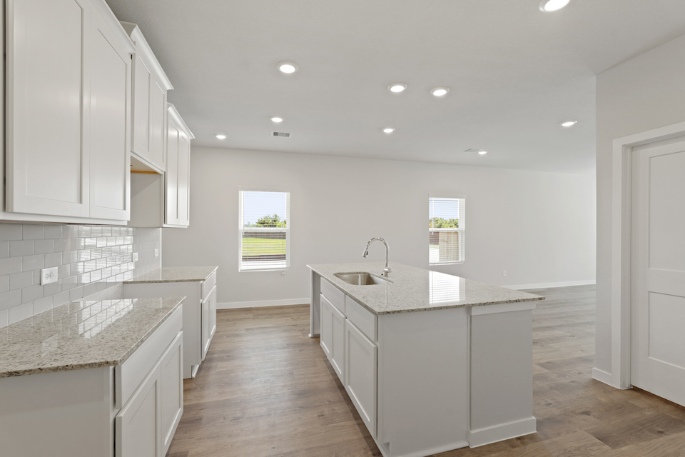A kitchen with white cabinets.