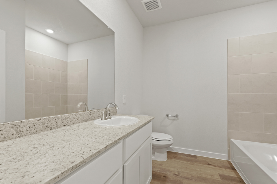 A bathroom with a marble countertop.