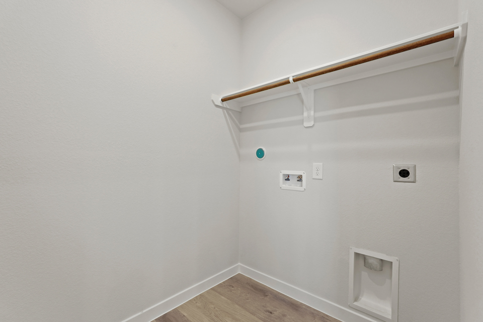 A white wall with a light fixture.