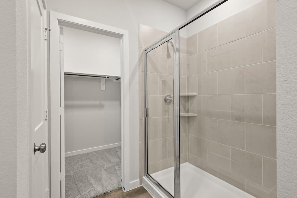 A shower with a glass door.