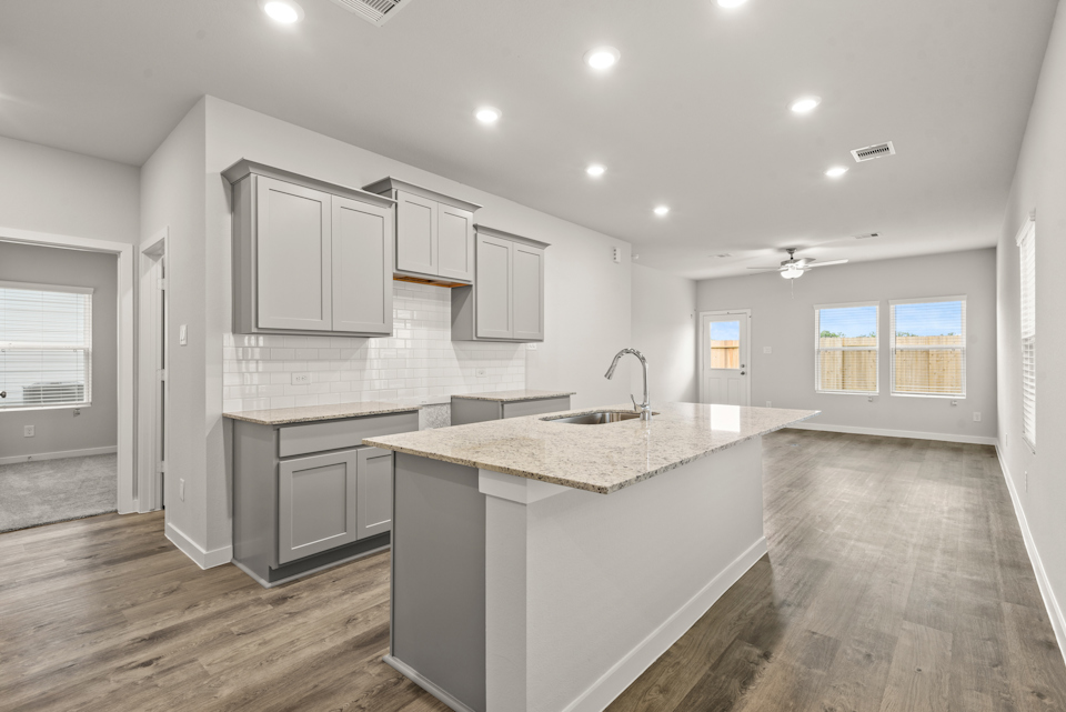 A kitchen with white cabinets.