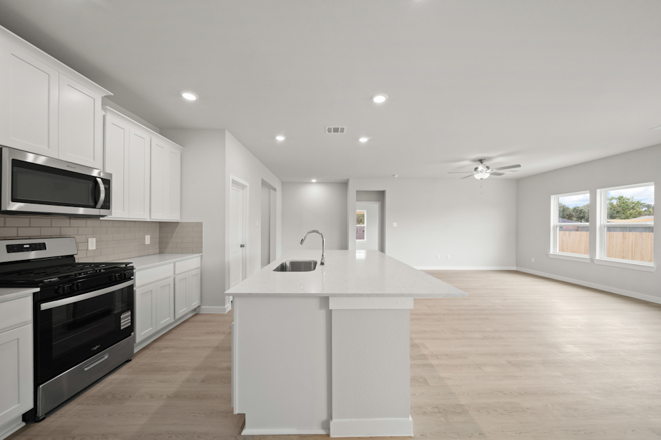A kitchen with white cabinets.