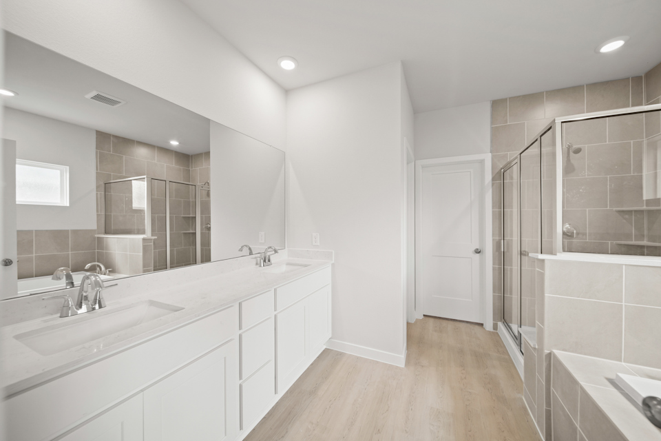 A bathroom with a large mirror.