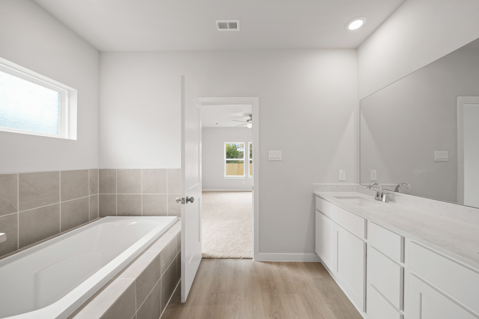 A bathroom with a tub and sink.