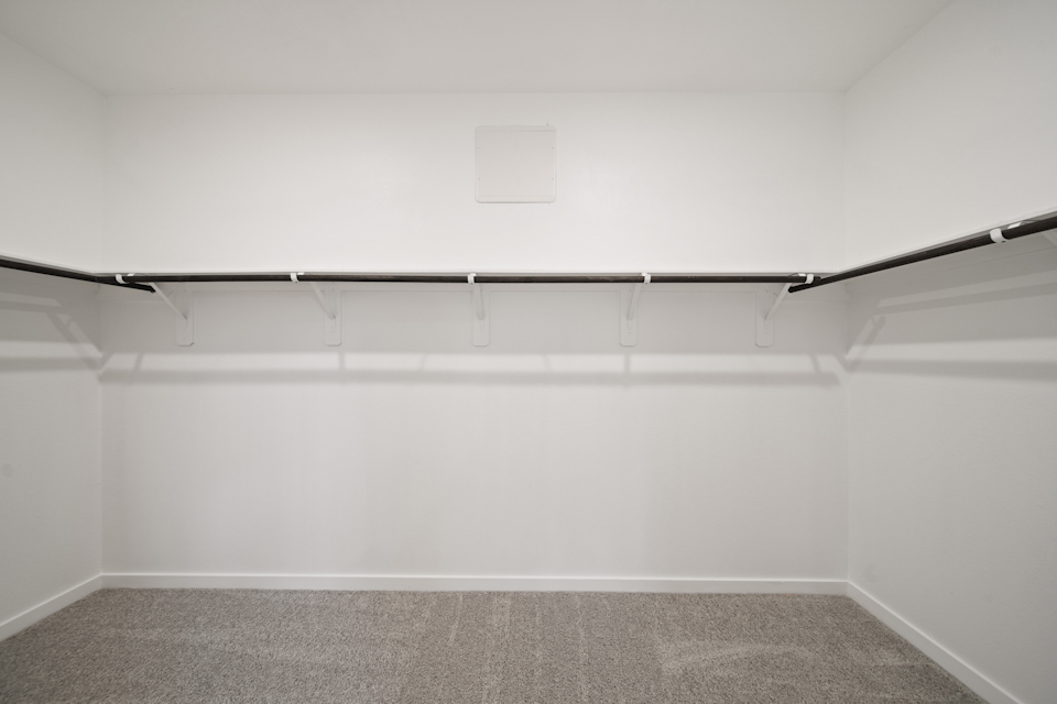 A white wall with a black floor.