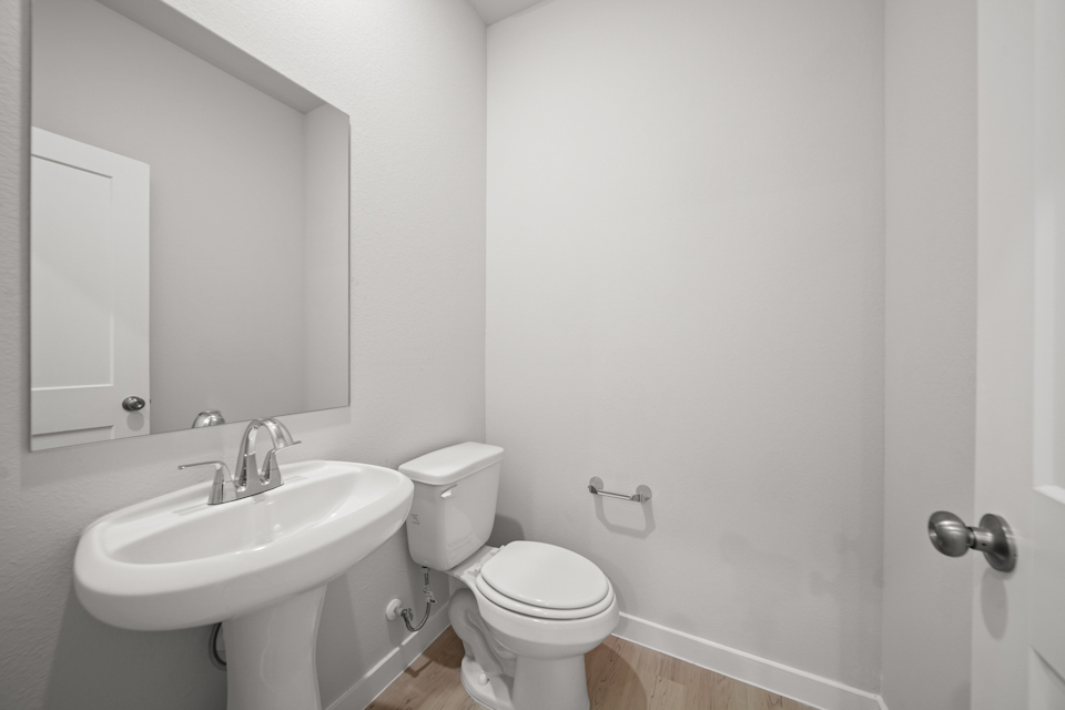 A bathroom with a toilet and sink.