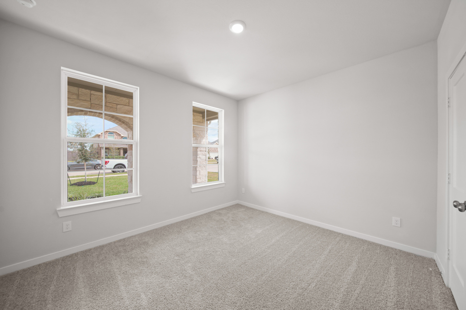 A room with a window and a door.