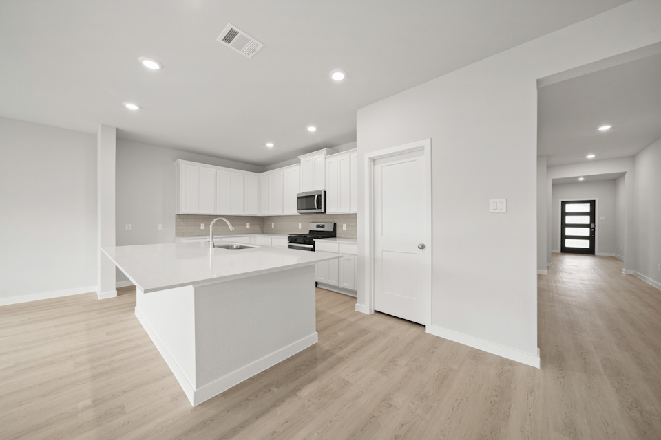 A kitchen with white cabinets.