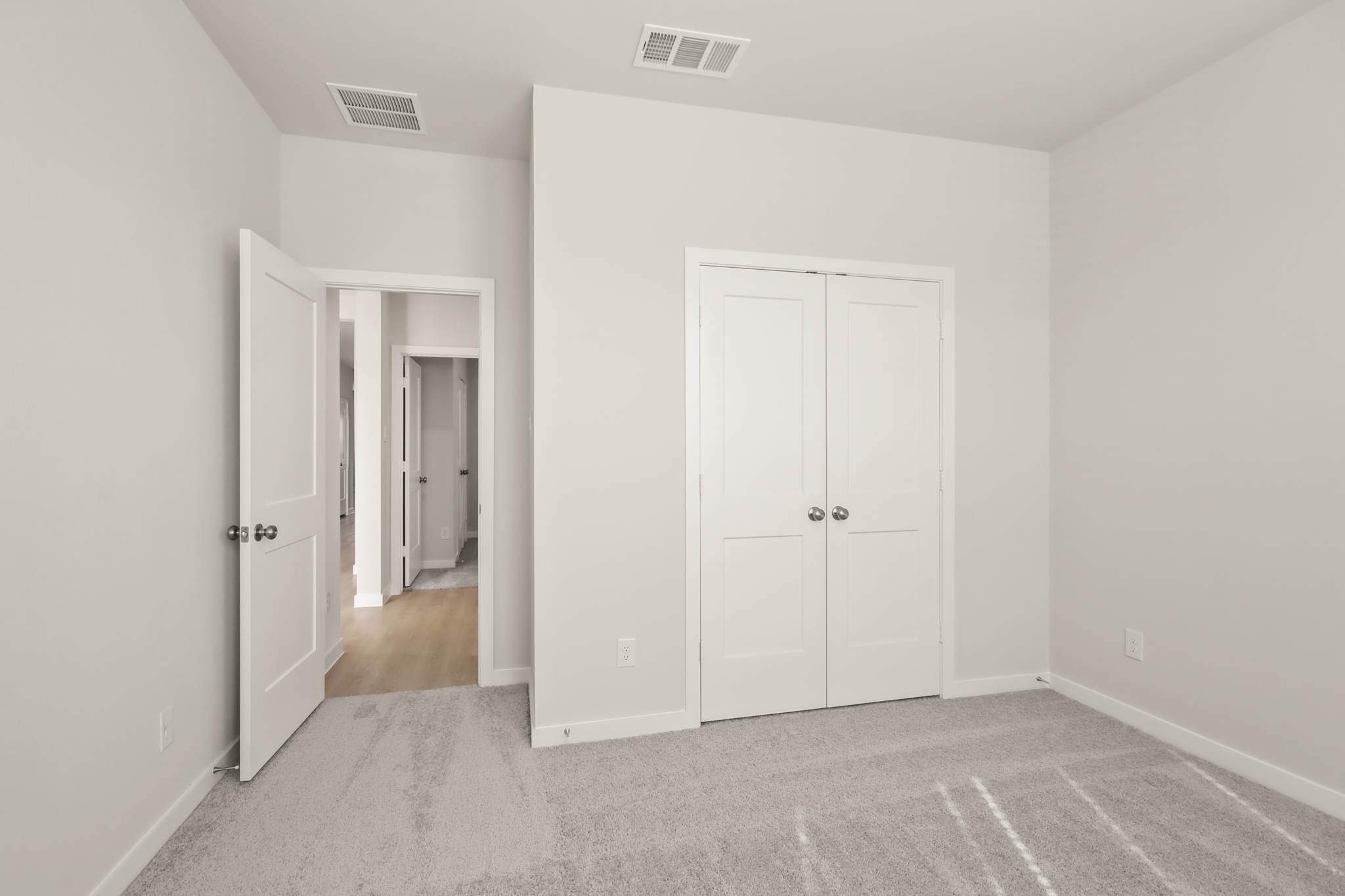 A hallway with white doors.