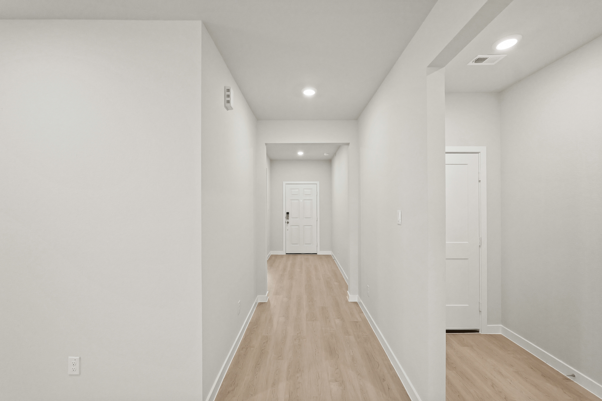 A hallway with white walls.
