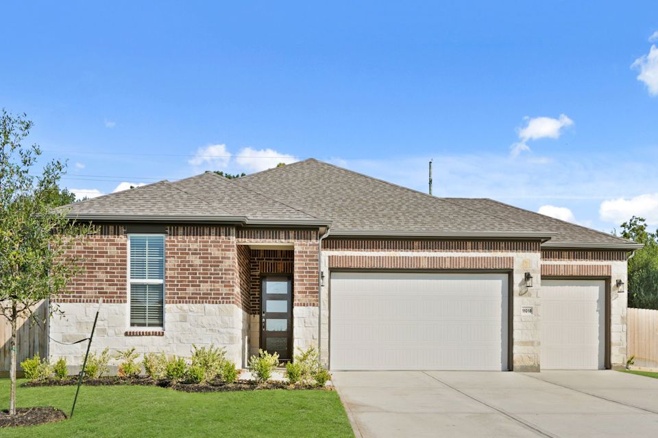 A house with garages and a driveway.