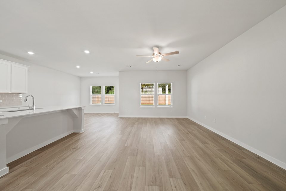 A large kitchen with a wood floor.