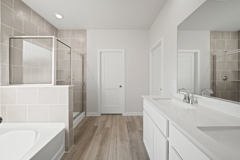 A bathroom with a large mirror.