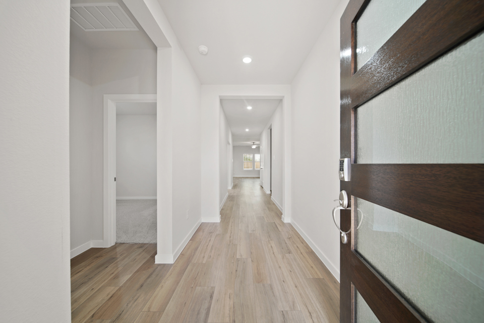 A hallway with wooden floors.