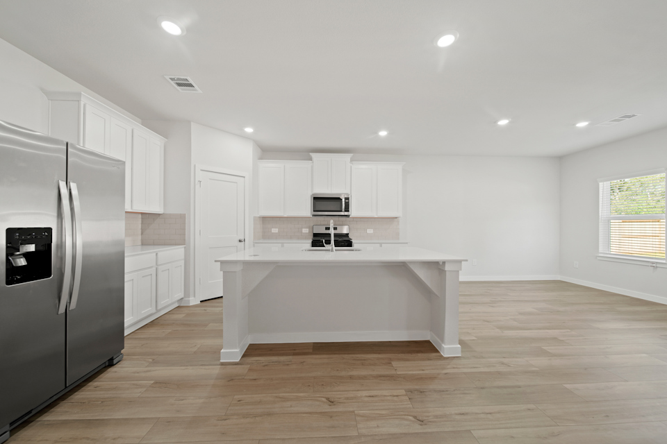 A kitchen with white cabinets.