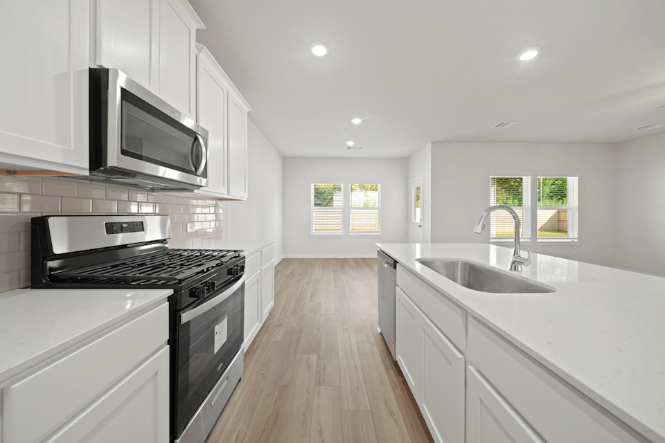 A kitchen with white cabinets.
