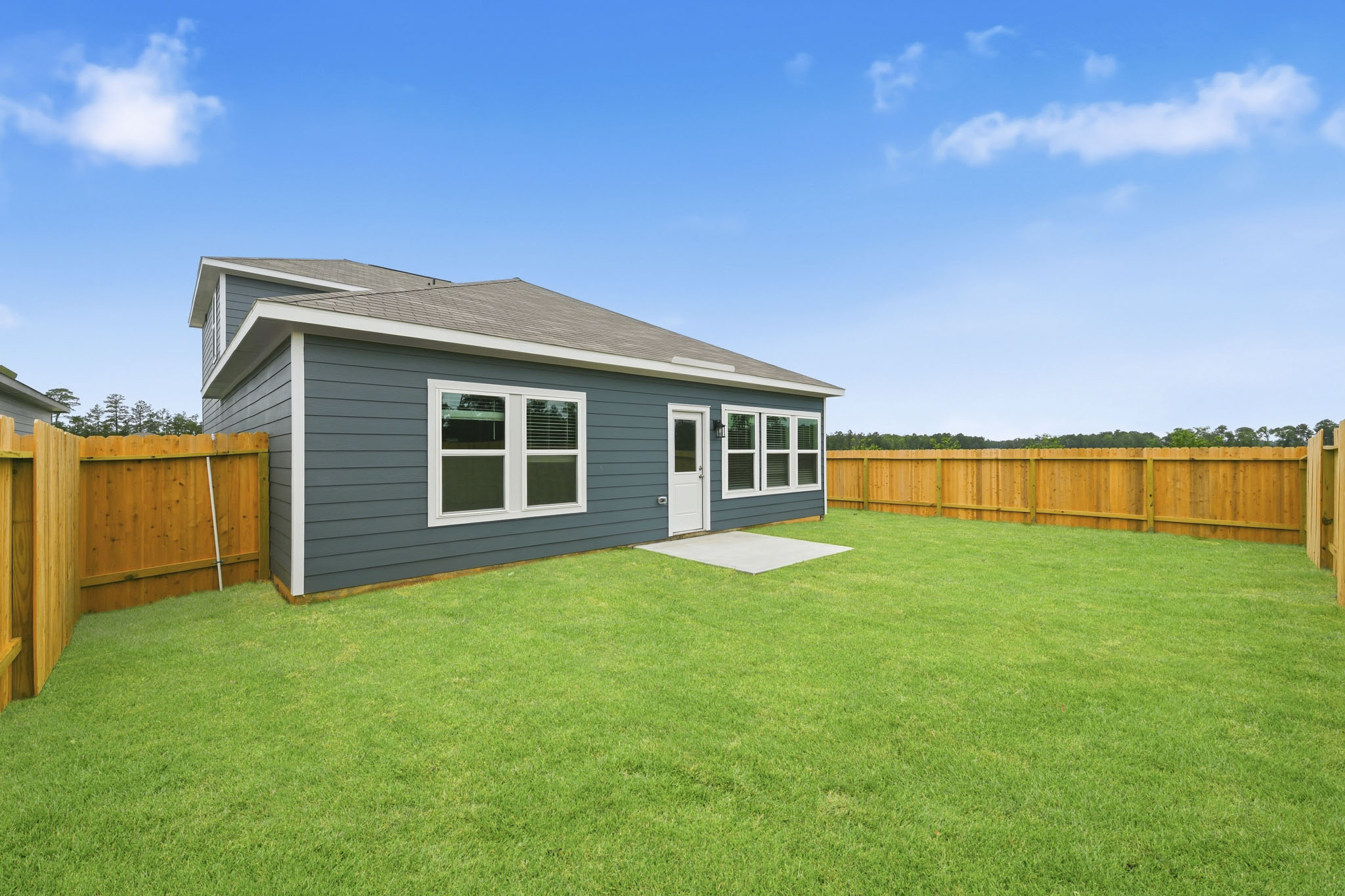 A house with a fence and grass.