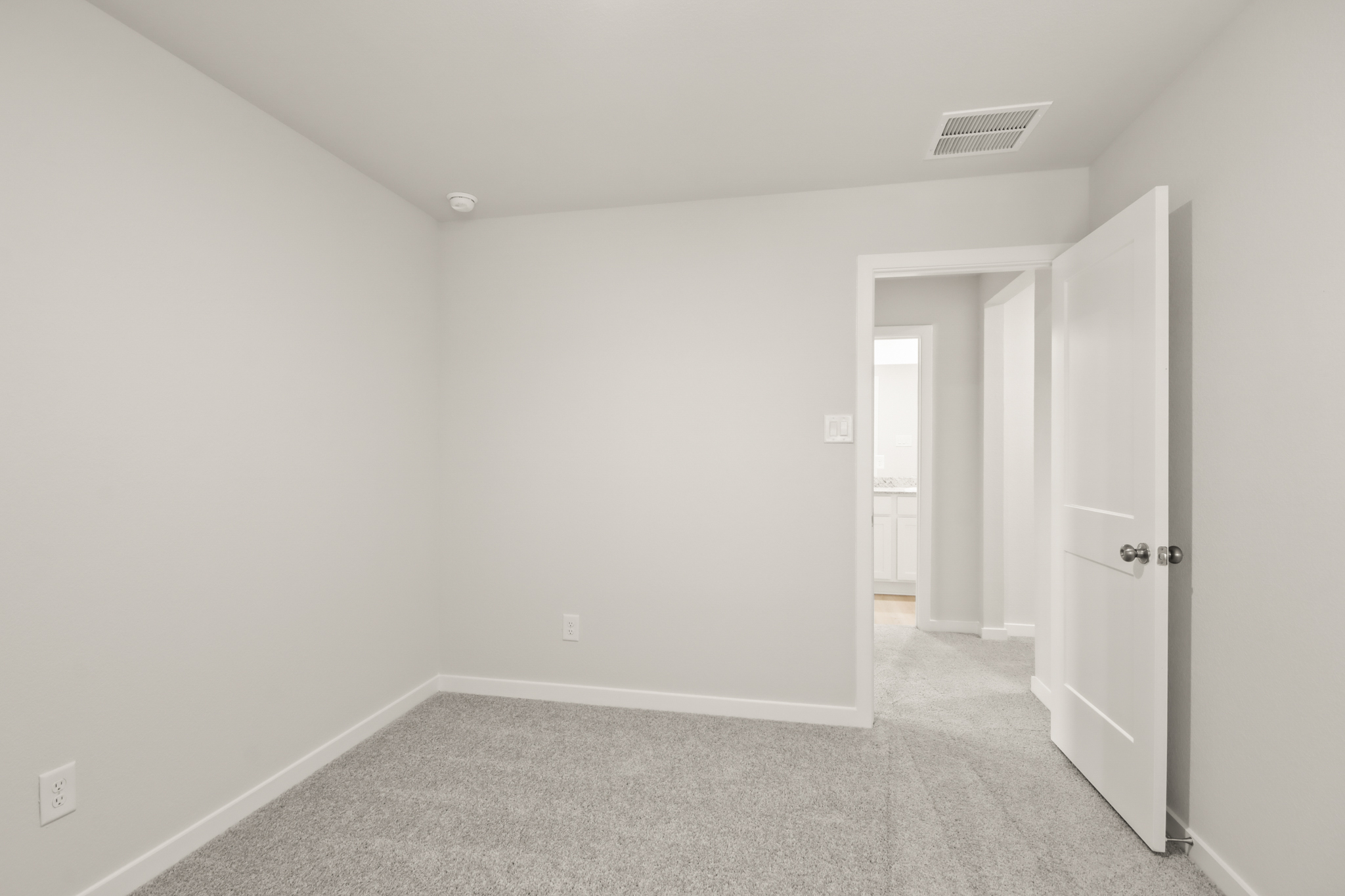 A hallway with white doors.