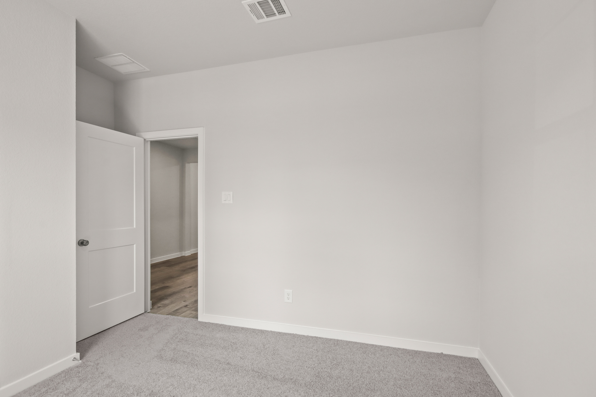 A hallway with white walls.