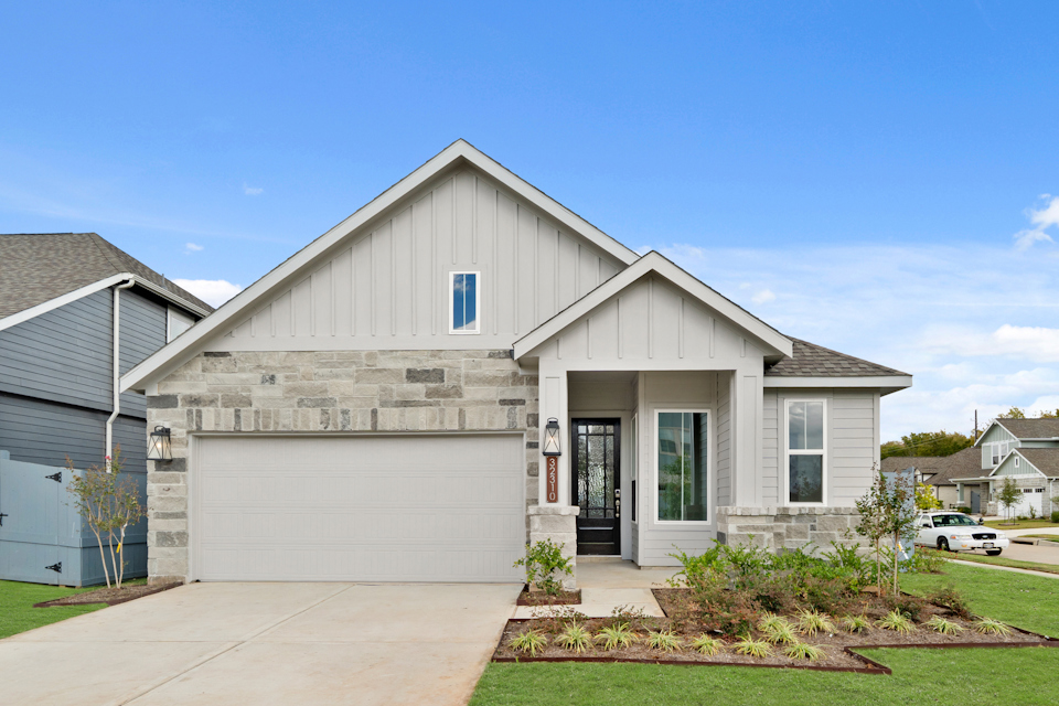 A white house with a garage.