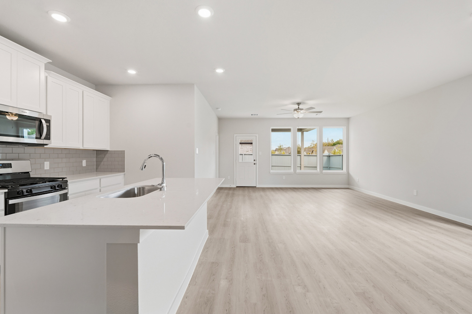 A kitchen with white cabinets.