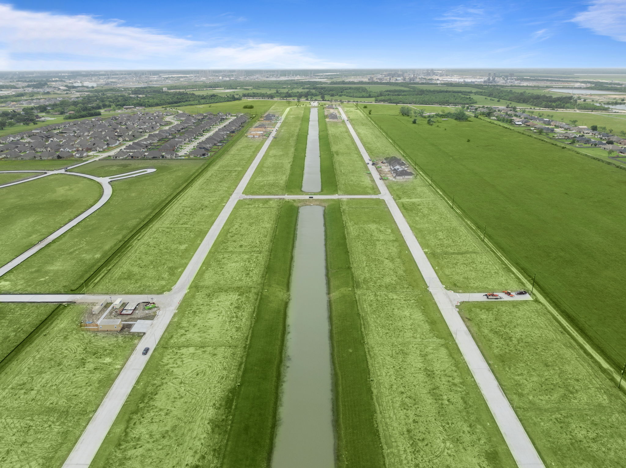 A road with grass and trees.