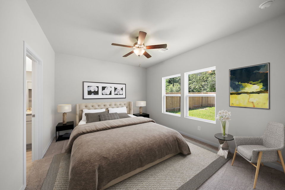 A bedroom with a bed and a fan.