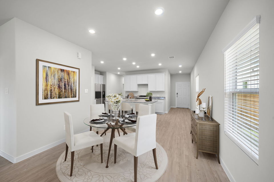 A dining room with a table and chairs.