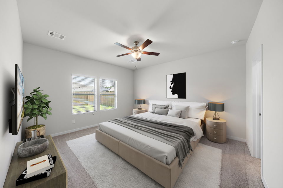 A bedroom with a bed and a fan.