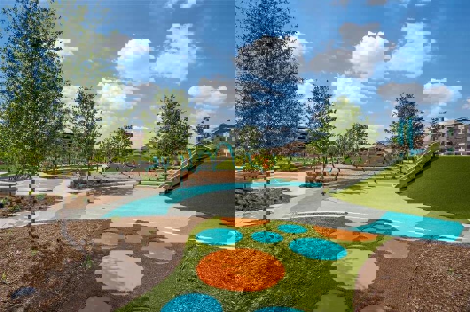 A large green park with a swimming pool.