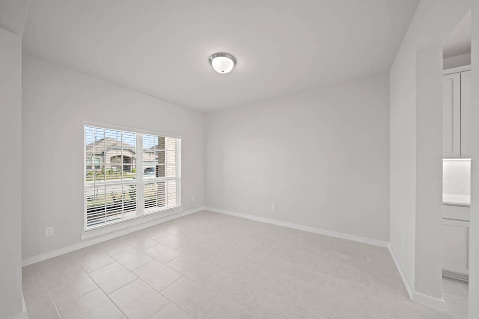 A room with a window and a tile floor.