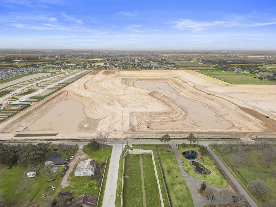 A large field with a road.