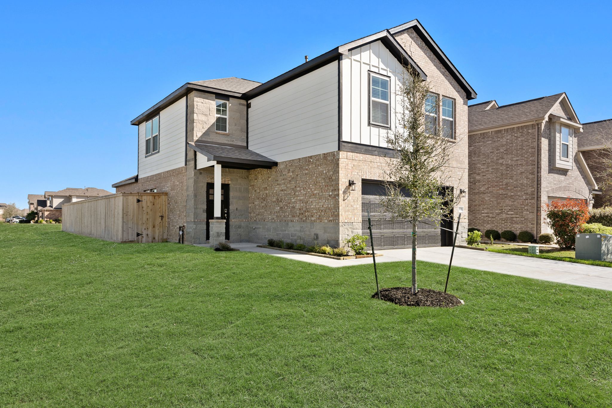 A large house with a green lawn.