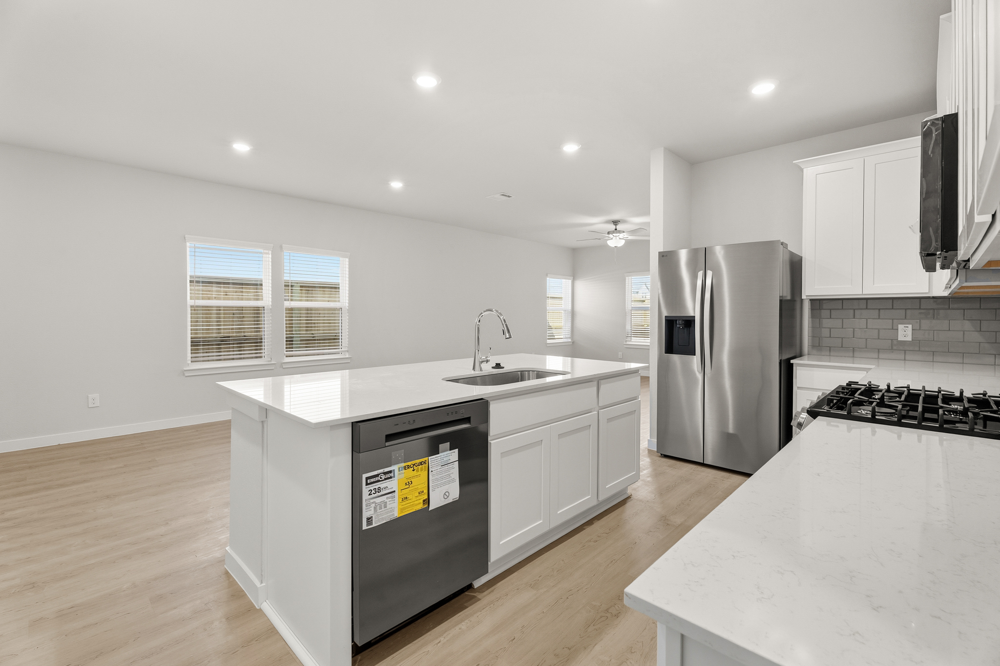 A kitchen with white cabinets.