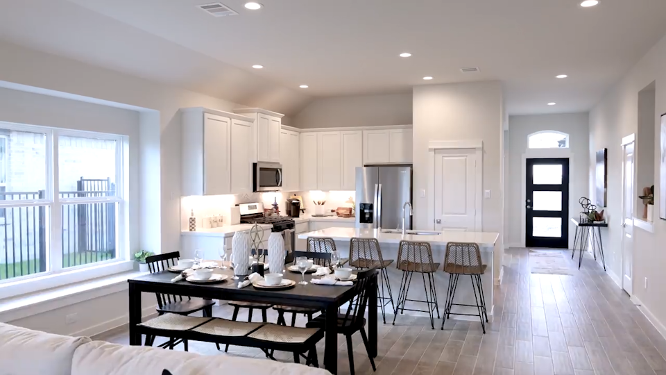 A kitchen with a dining table.
