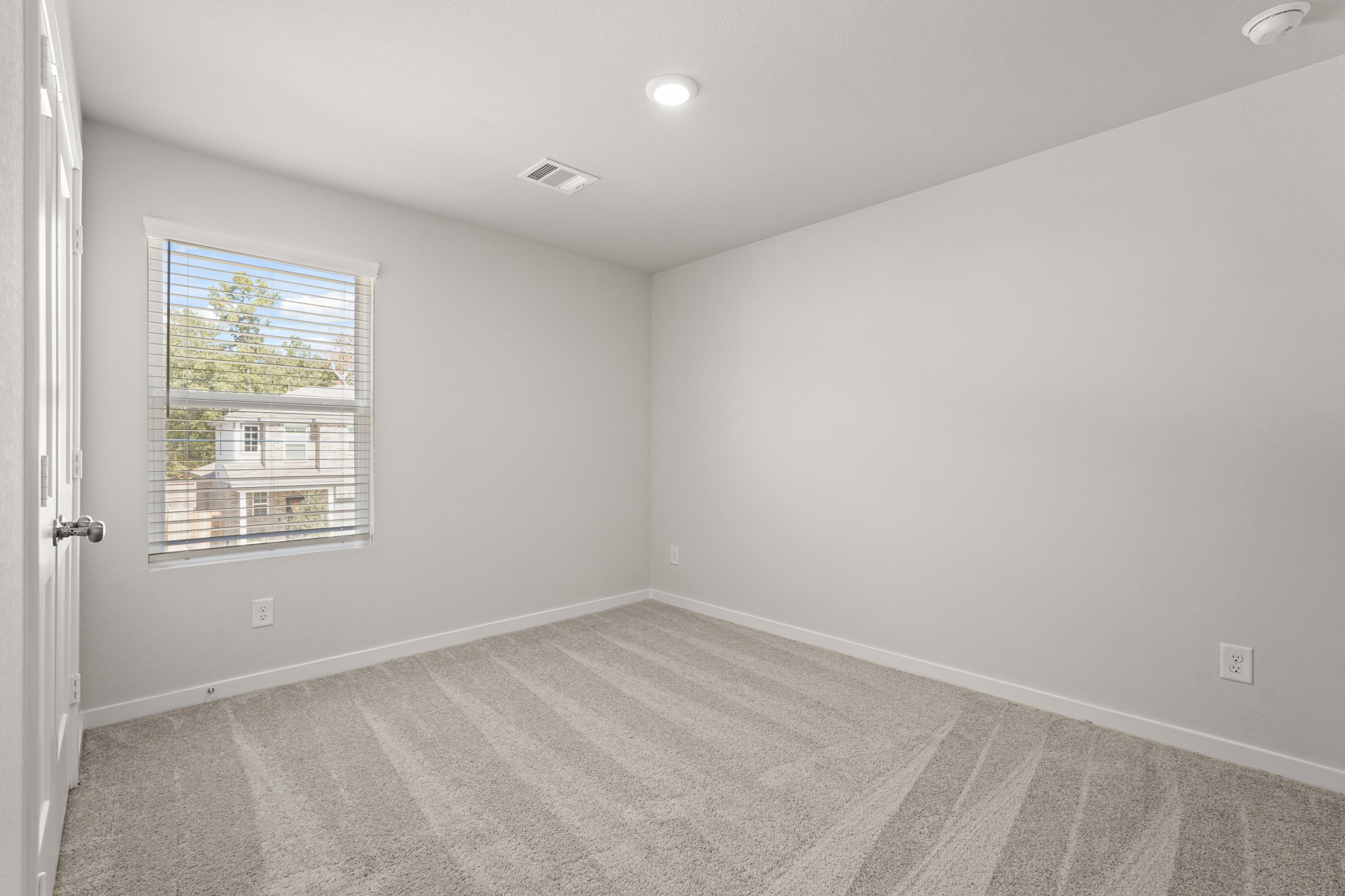 A room with a window and a door.