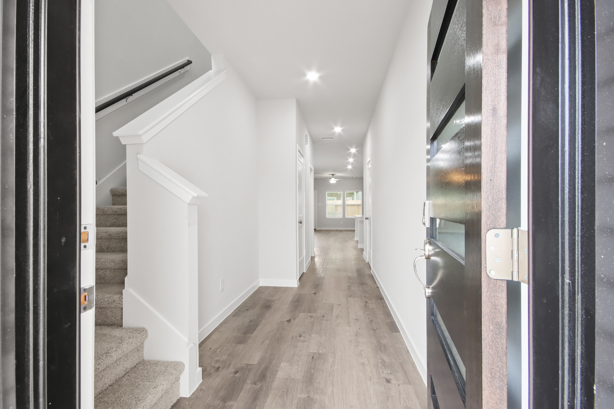 A hallway with white walls.