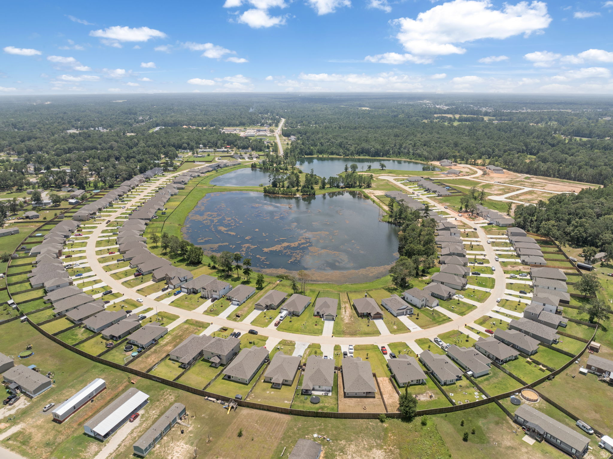 A large area with a pond and buildings around it.