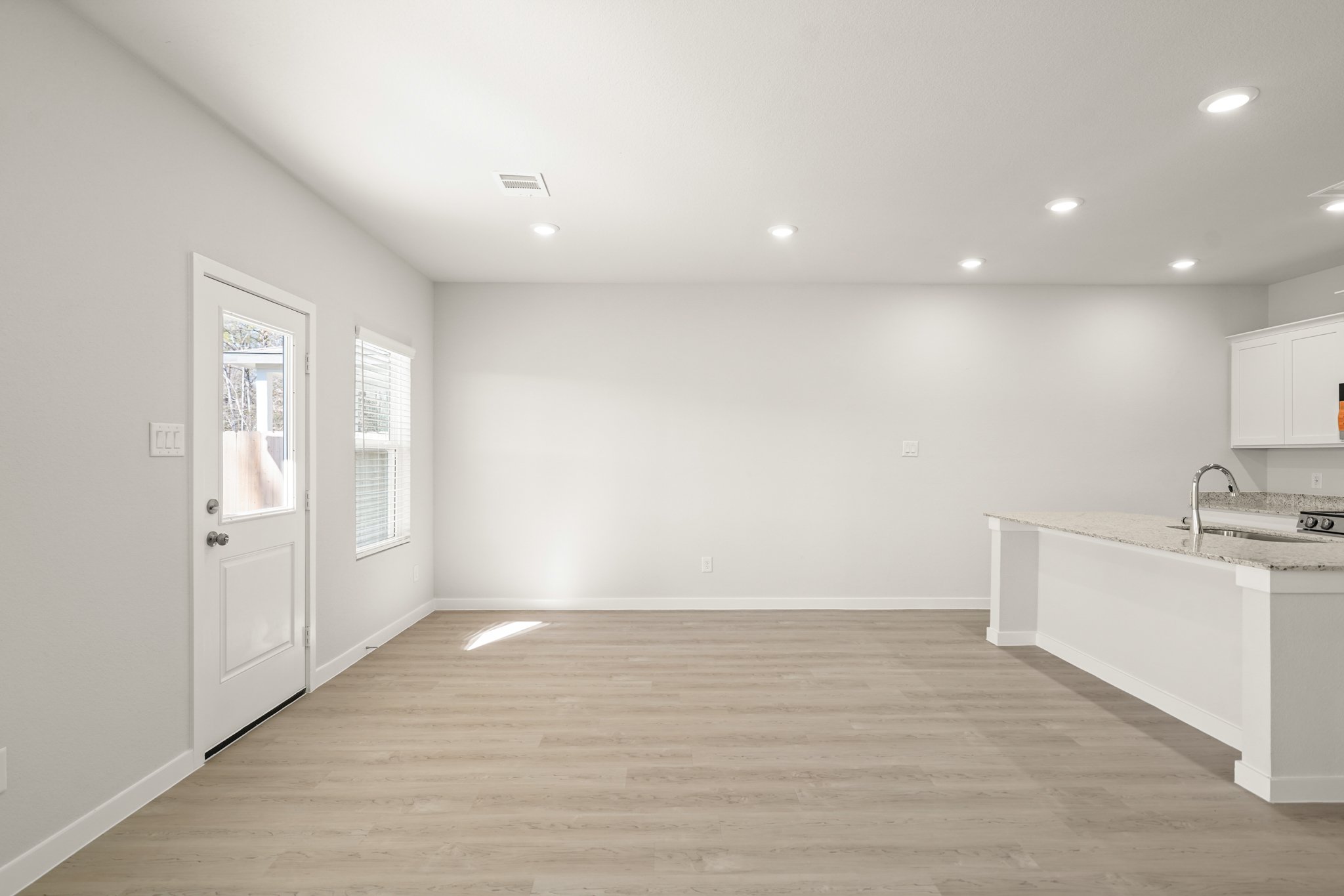 A kitchen with white cabinets.