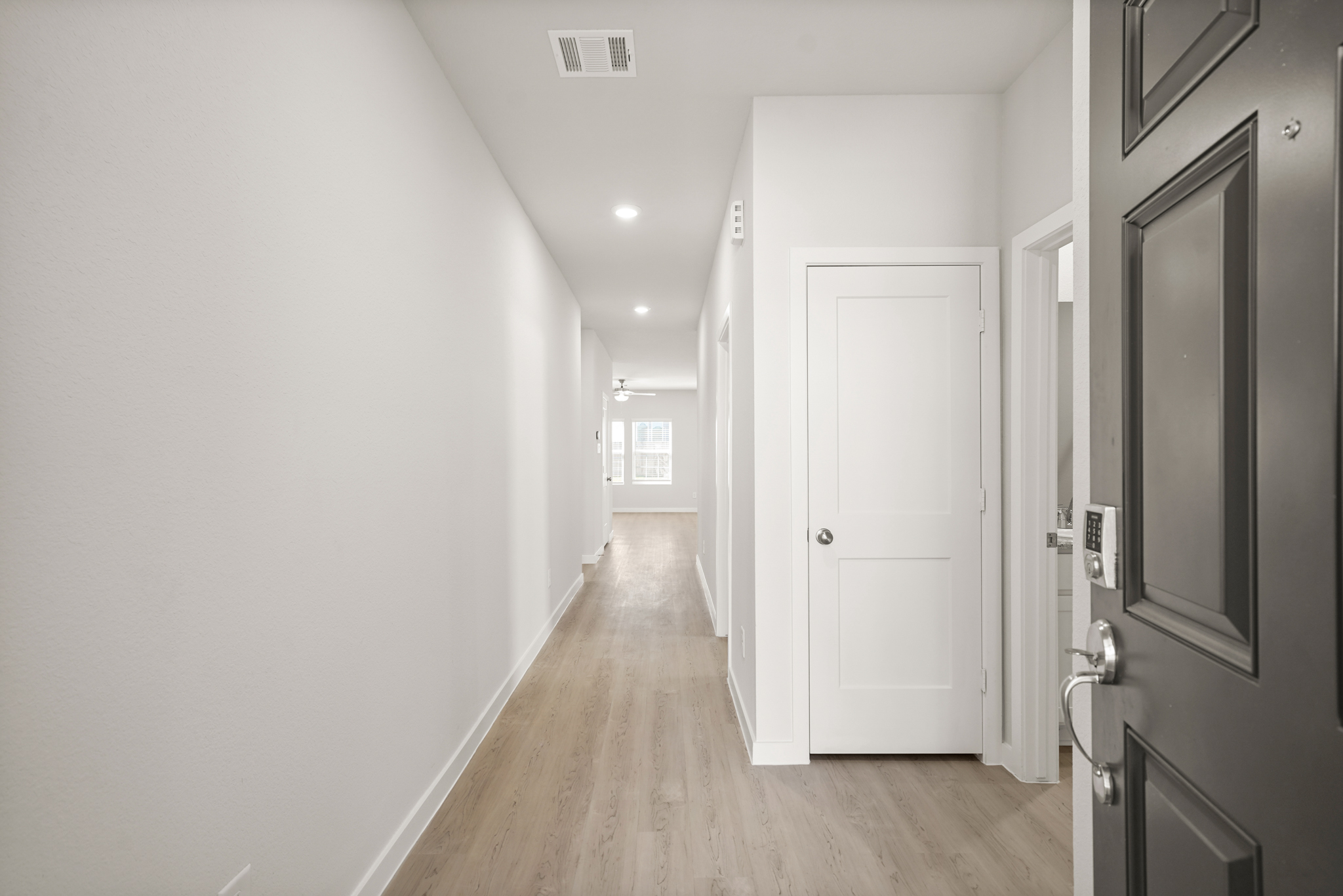 A hallway with white doors.