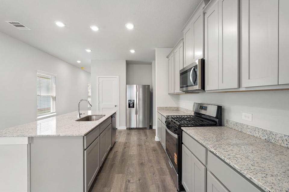 A kitchen with white cabinets.