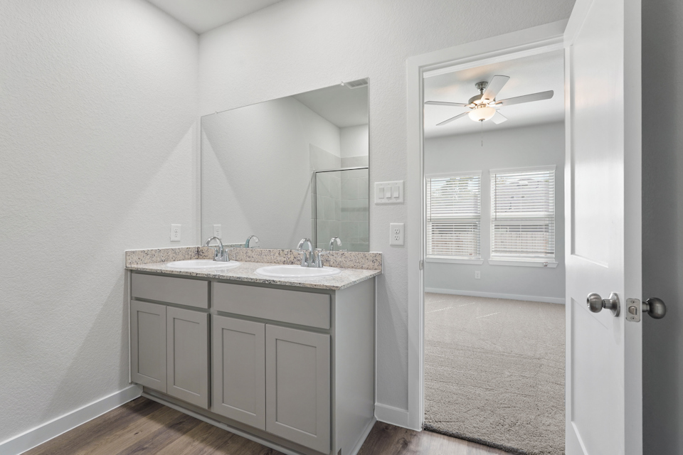 A bathroom with a sink and a mirror.