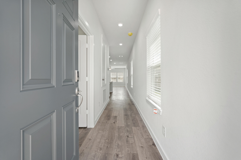 A hallway with white doors.