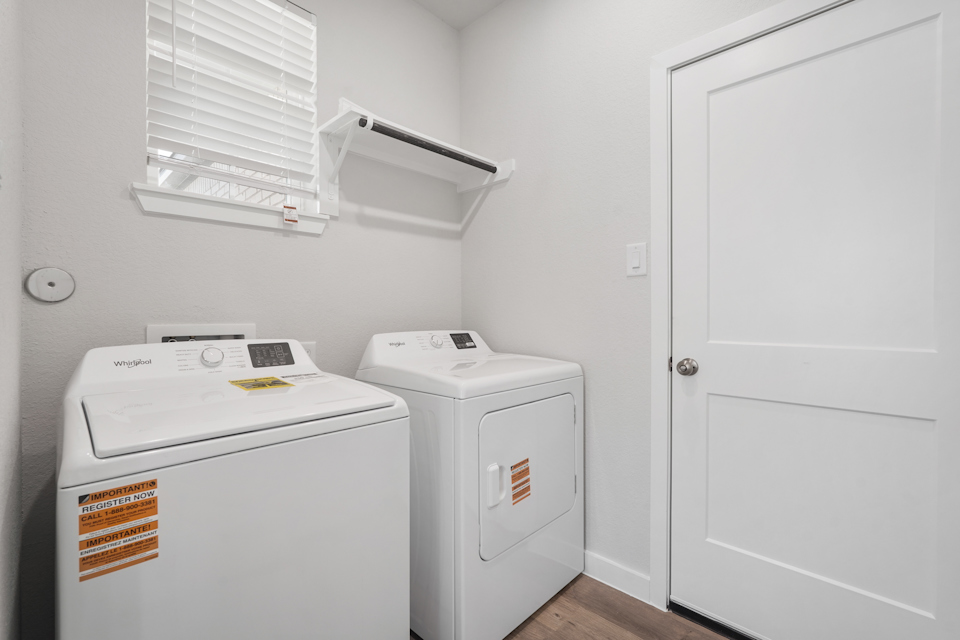 A washing machine and dryer in a room.