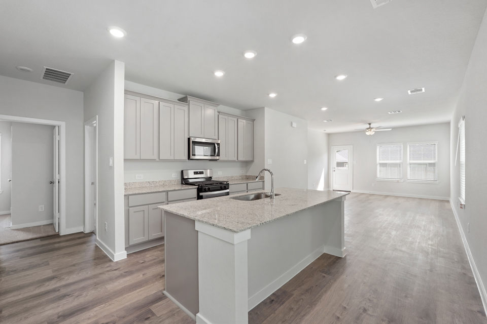 A kitchen with white cabinets.
