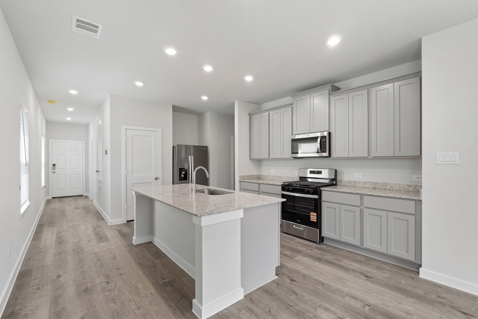 A kitchen with white cabinets.